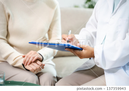 Psychiatrist comforting stressed patient during mental health therapy. Psychology counseling, emotional support, depression and anxiety treatment Psychiatrist comforting stressed patient during mental health therapy. Psychology counseling, emotional support, depression and anxiety treatment 137359943