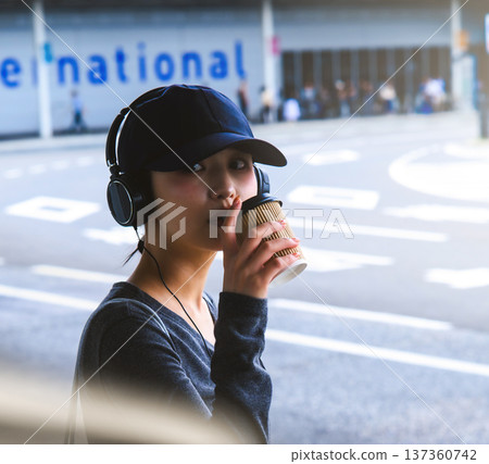 A woman drinking coffee at the airport. Photo courtesy of Kansai International Airport (KIX). A woman drinking coffee at the airport. Photo courtesy of Kansai International Airport (KIX). 137360742