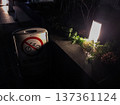 Public telephone illuminated by street lights at night 137361124