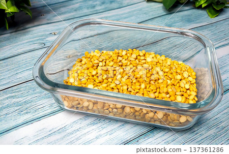 Split Chickpea Also Know as Chana Dal, Dried Chickpea Lentils in Glass Container on Wooden Background Split Chickpea Also Know as Chana Dal, Dried Chickpea Lentils in Glass Container on Wooden Background 137361286