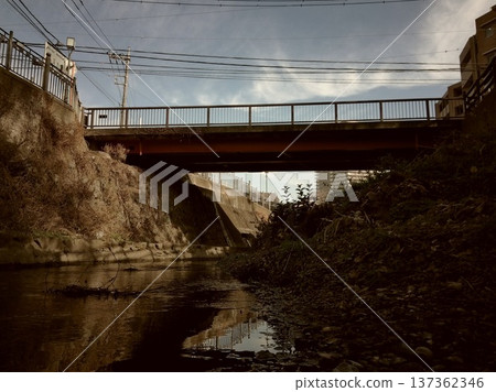 Looking up at the underpass, rusty iron poles and concrete structures 137362346