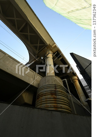 Looking up at the underpass, rusty iron poles and concrete structures Looking up at the underpass, rusty iron poles and concrete structures 137362349