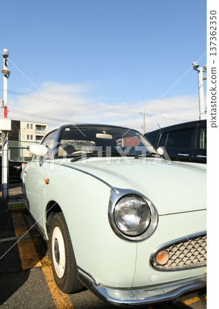 Nissan Figaro retro Pike car parked under the blue sky 137362350
