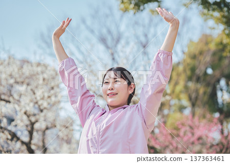 A woman stretching outdoors. Warming up before and after running. Healthy exercise habits. 137363461