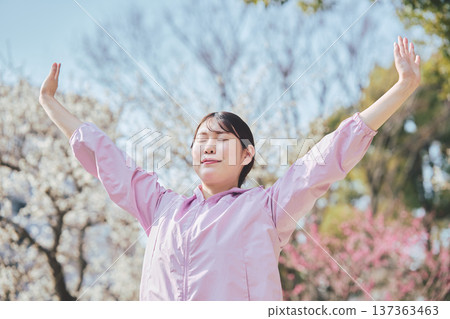 A woman stretching outdoors. Warming up before and after running. Healthy exercise habits. 137363463