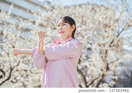 A woman stretching outdoors. Warming up before and after running. Healthy exercise habits. 137363468