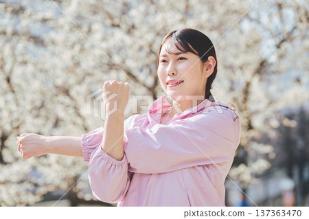 A woman stretching outdoors. Warming up before and after running. Healthy exercise habits. 137363470