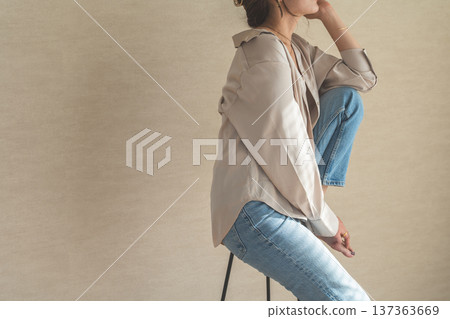 High chair, female model in denim sitting on chair High chair, female model in denim sitting on chair 137363669