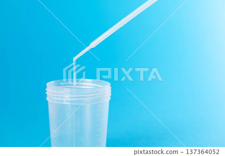 Prostate fluid collection for analysis against a blue background. Bacteriological culture for pathogenic bacteria in the prostate. Copy space for text 137364052