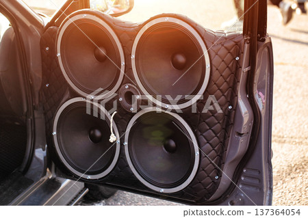 Car Door Trimmed In Quilted Leather With Four Large Speakers. Powerful Custom Auto Sound Equipment. 137364054