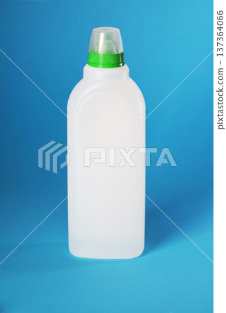 White plastic bottle with green and transparent cap for dishwashing machine rinse aid or salt solution product against blue background White plastic bottle with green and transparent cap for dishwashing machine rinse aid or salt solution product against blue background 137364066