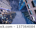 Upward night view of New York City skyscrapers forming dramatic urban canyon 137364084