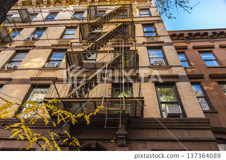 Historic apartment building facade with metal fire escape in New York City Historic apartment building facade with metal fire escape in New York City 137364089