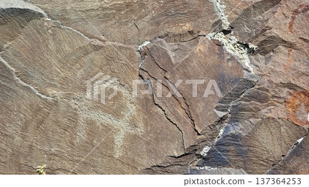 Stone wall texture background. Rocks with petroglyphs. Stone wall texture background. Rocks with petroglyphs. 137364253