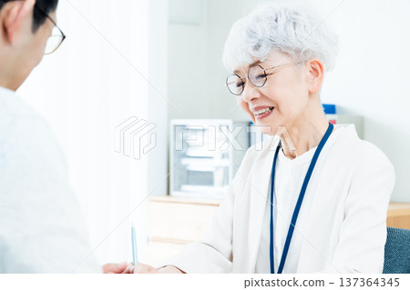 Senior woman receiving consultation Senior woman receiving consultation 137364345