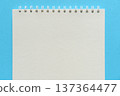 Blank spiral sketchbook on a bright blue background - top view 137364477