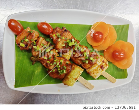 Grilled Chicken Yakitori Skewers with Teriyaki Glaze and Vegetable Garnish Grilled Chicken Yakitori Skewers with Teriyaki Glaze and Vegetable Garnish 137365681