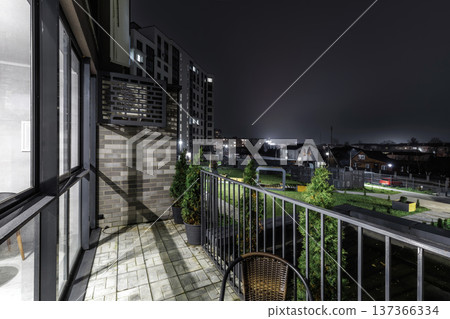 Modern Apartment Balcony View at Night with Courtyard 137366334