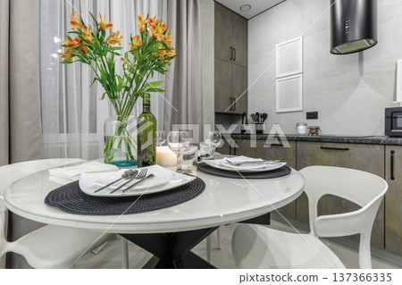 Cozy Dining Table Setting with Flowers in Modern Apartment 137366335