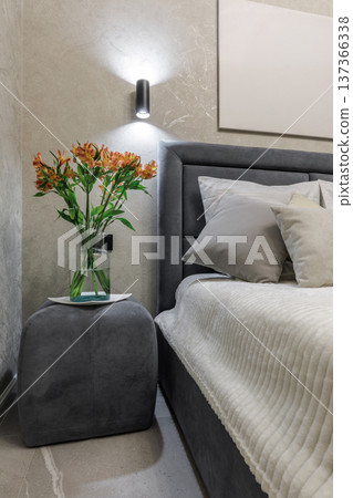Modern Bedroom Interior with Flowers on Nightstand 137366338