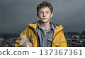 Portrait of a Young Boy in a Yellow Jacket Against a Darkened Sky with Market Background, Conveying  137367361