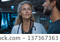 Professional female doctor engaged in conversation with male patient in a modern medical facility en 137367363