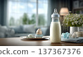 Stylish Baby Bottle on a Wooden Table Surrounded by Soft Furniture and Decorative Elements in A Cozy 137367376