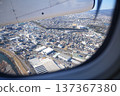 Aerial view of the city from the window of a propeller plane 137367380