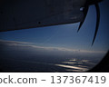 Aerial view of the coastline and city from the wing of a propeller plane 137367419
