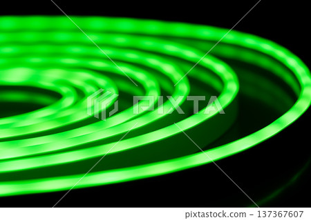 Green glowing LED neon rope light spiral on black background Green glowing LED neon rope light spiral on black background 137367607