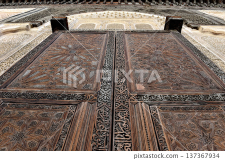 Carved wooden door details with geometric patterns, Bou Inania Madrasa. Fez, Morocco Carved wooden door details with geometric patterns, Bou Inania Madrasa. Fez, Morocco 137367934