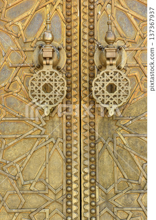 Brass doors adorned with Moroccan patterns, metal filigree, and intricate relief work. Royal Palace, Fez, Morocco Brass doors adorned with Moroccan patterns, metal filigree, and intricate relief work. Royal Palace, Fez, Morocco 137367937