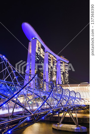 Night view of The Helix Bridge and the Marina Bay Sands Resort, Singapore, it's a pedestrian bridge linking the Marina Centre with Marina South. Night view of The Helix Bridge and the Marina Bay Sands Resort, Singapore, it's a pedestrian bridge linking the Marina Centre with Marina South. 137368390