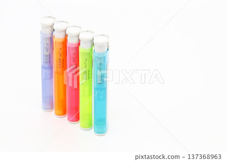 Colorful disposable lighters lined up on a white background_right margin 137368963