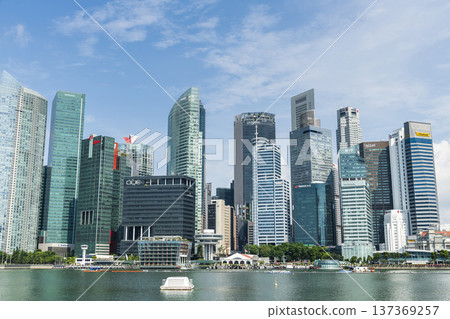 Building view of modern skyscrapers along Marina Bay in the Raffles Place financial district from the Marina Bay Sands observation deck, Singapore. Building view of modern skyscrapers along Marina Bay in the Raffles Place financial district from the Marina Bay Sands observation deck, Singapore. 137369257