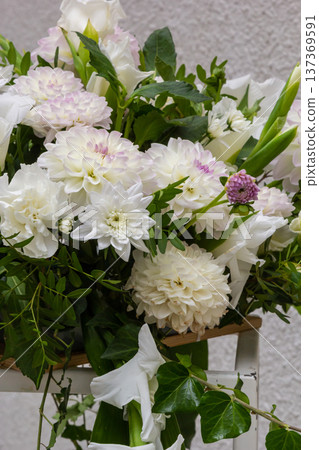 Beautiful white floral arrangement with greenery in a decorative display 137369591