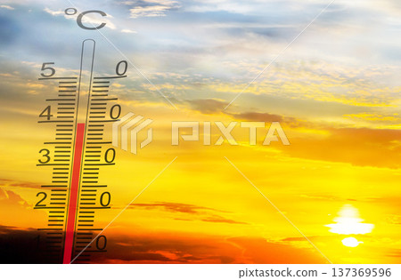 Sunrise views with a thermometer showing rising temperatures during a warm summer morning in a clear sky 137369596