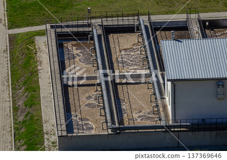 Water purification facilities with filtration tanks and treatment systems located outdoors under clear skies during daylight Water purification facilities with filtration tanks and treatment systems located outdoors under clear skies during daylight 137369646