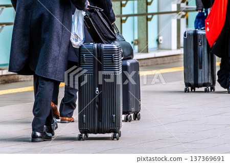 Yokohama cityscape, Japan. Businessmen and elderly men walking on the pedestrian deck in front of Shin-Yokohama Station 137369691