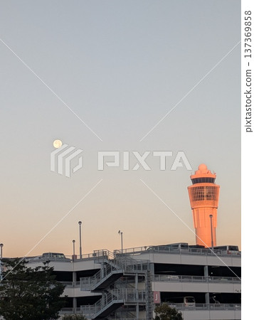 Evening sky with the moon and airport control tower Airport facilities scenery 137369858