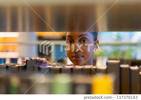 Focused Student Browsing Library Books Focused Student Browsing Library Books 137370183