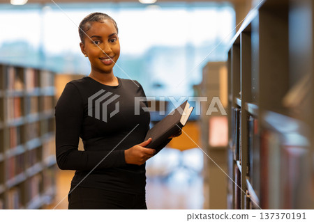 Student reading a book in library 137370191