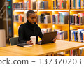 Student studying in modern library 137370203