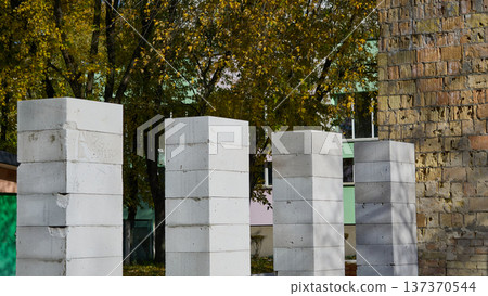 Support pillars made of brick blocks for building a wall 137370544
