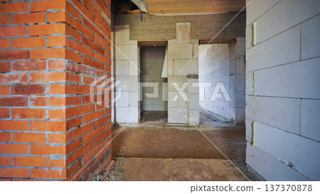 Interior building site showing walls of red bricks and aerated concrete blocks 137370878