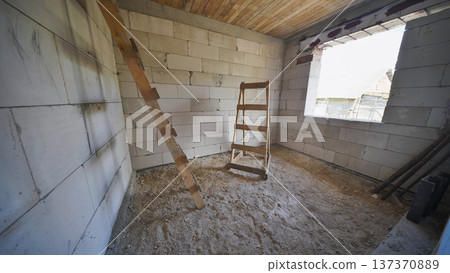 Unfinished house showing rooms and wooden ladder during renovation Unfinished house showing rooms and wooden ladder during renovation 137370889