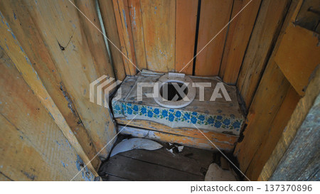 Old wooden toilet in a slavic village standing in the backyard Old wooden toilet in a slavic village standing in the backyard 137370896