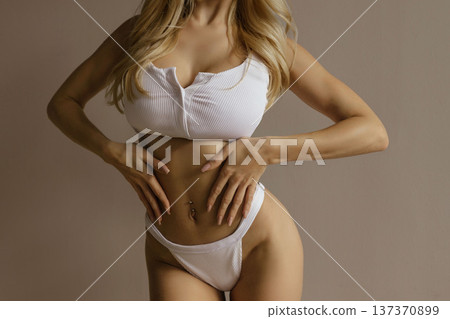 Sexy beauty fitness concept with busty woman in white lingerie, slim waist, feminine body and healthy lifestyle 137370899