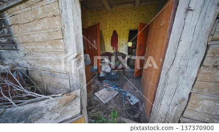 Abandoned old wooden house interior showing decay and neglected belongings Abandoned old wooden house interior showing decay and neglected belongings 137370900