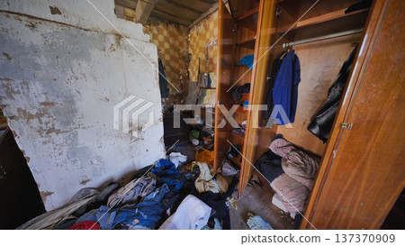 Abandoned bedroom interior showing domestic neglect and extreme hoarding disorder 137370909